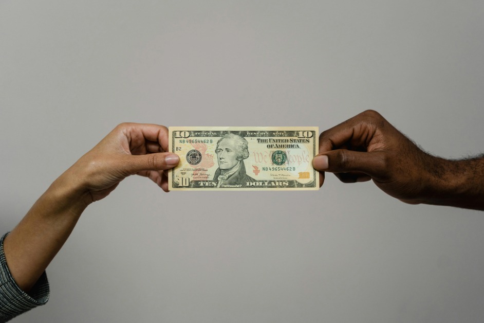 Nigerian freelancer receiving a ten-dollar bill from an international client