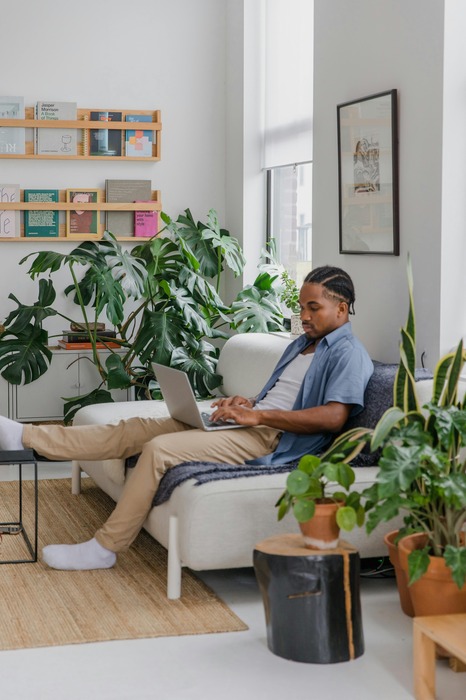 Nigerian remote worker working on his laptop in order to receive cross-border payments