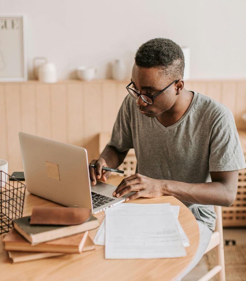 Nigerian freelancer working on his laptop to get paid in crypto