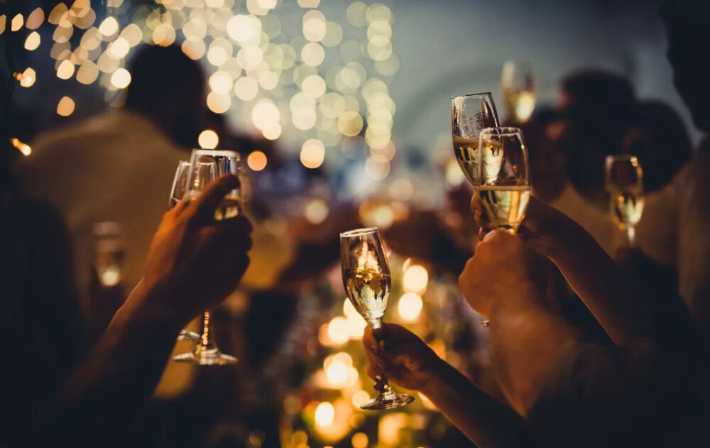 Crypto payment QR beside cocktail and meal at Lagos restaurant.