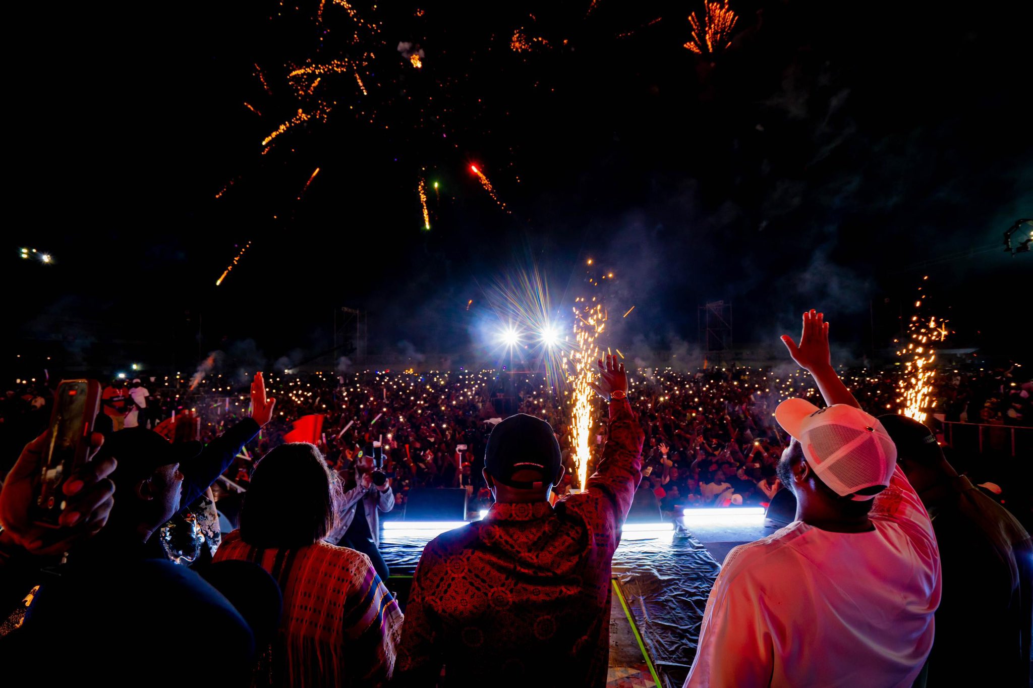 Crowd at Lagos beach party raising hands